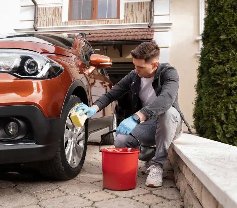 Lavage auto à domicile Saint-Quentin-les-Chardonnets : professionnel intervenant sur un véhicule